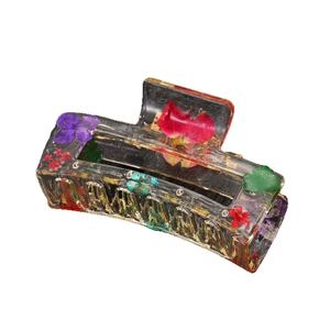 Transparent acrylic hair claw clip with real purple dried flowers and green leaves