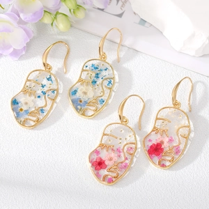 Artistic face profile earrings with real pressed dried flowers in resin and gold metal outlines