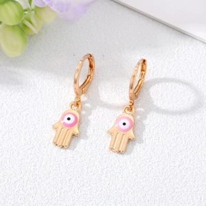 Golden Hamsa Hand earrings with evil eye detail in a 45-degree stylish top view