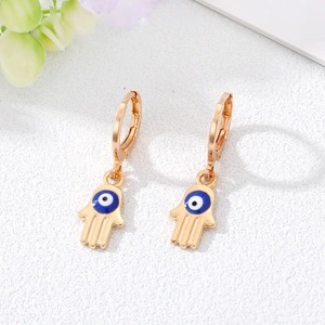 Golden Hamsa hand hoop earrings with blue evil eye detail and lever-back closure