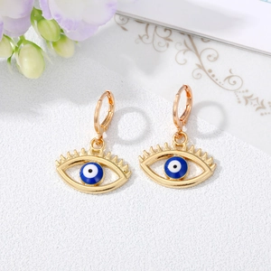 Retro gold hollow evil eye earrings with blue enamel bead and eyelash details