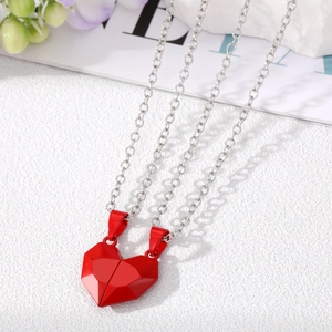 Magnetic heart pendant necklaces for couples featuring red geometric facets on silver chains