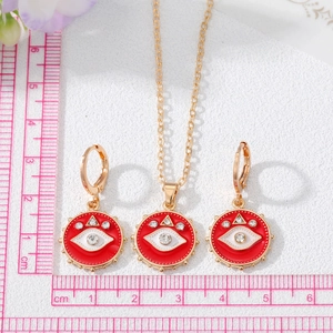 Detail eines roten Evil Eye Schmucksets mit Größenangabe neben einem Lineal