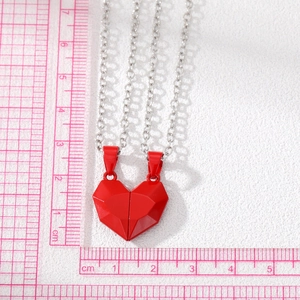 Detail of red heart magnetic necklaces for couples with size scale on white background