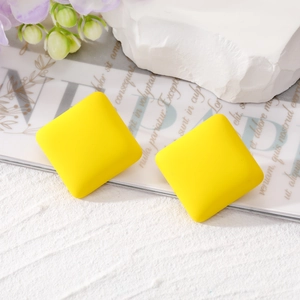 Minimalist square macaron yellow matte geometric stud earrings for women on a floral background
