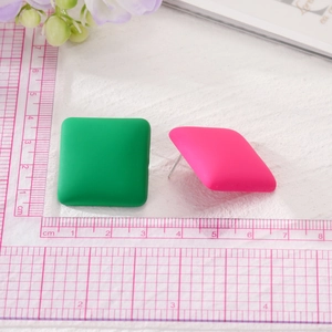 Detail view of macaron square earrings with matte green and pink finish and size scale