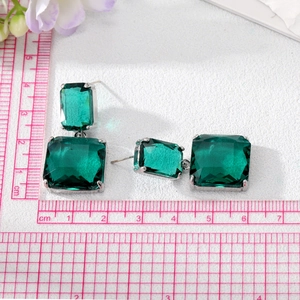 Elegant emerald green square crystal drop earrings with silver metal prong setting