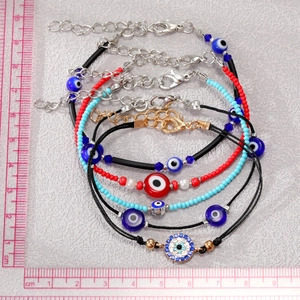 Bohemian evil eye beaded bracelet set with blue beads and metal chain details
