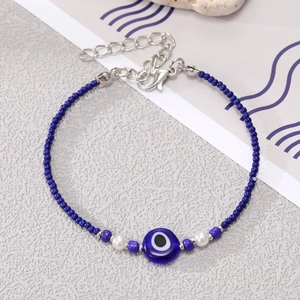 Detailed close-up of bohemian evil eye bead bracelet with silver lobster clasp and chain