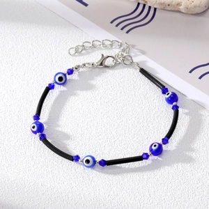 Macro detail of Bohemian Evil Eye bead bracelet with blue crystals and lobster clasp