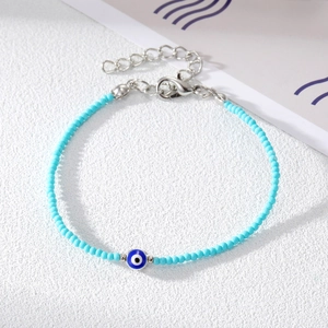 Detail of light blue beaded evil eye bracelet with silver lobster clasp and extender chain