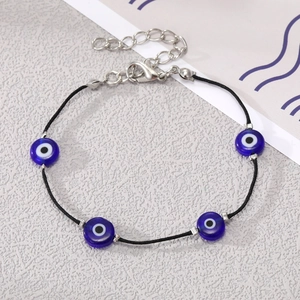 Detail of Bohemian evil eye bracelet featuring blue glass beads and adjustable silver chain