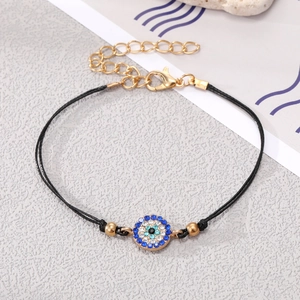 Detail shot of Evil Eye beaded bracelet with blue rhinestones and adjustable gold chain
