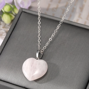Polished natural pink crystal heart pendant necklace with a delicate silver chain