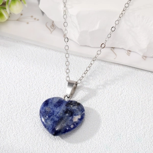 Close-up of heart-shaped natural blue stone pendant on a silver-tone chain necklace