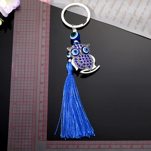 Vintage owl keychain with blue evil eye beads and long silk tassel in silver finish