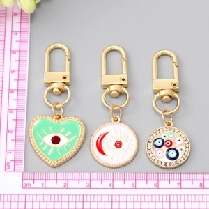 Evil Eye heart and sun charms in gold enamel, set of three keychains with size scale