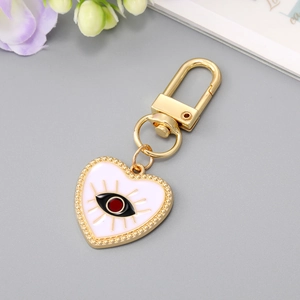 Creative gold heart-shaped evil eye keychain with enamel detailing and blue eye charm