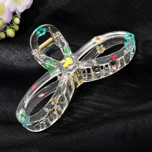 Transparent resin shark hair clip with dried sunflower petals and green leaves