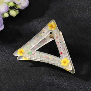 Matte triangle hair claw clip with embedded dried flowers and metallic spring detail