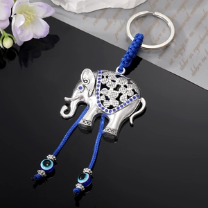 Vintage elephant keychain with blue rhinestones, evil eye beads, and tassel ornament