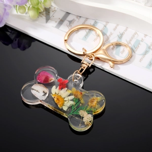 Creative dog bone shaped keychain with real dried flowers in clear acrylic resin