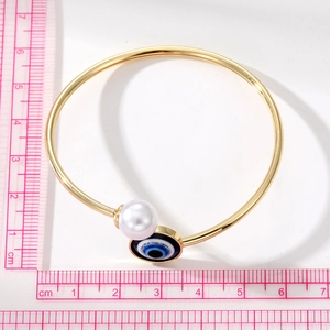 Golden open bangle with evil eye charm and white pearl, adjustable 6.5cm diameter jewelry