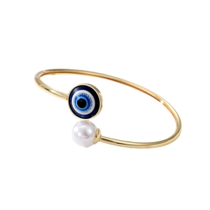 Adjustable gold evil eye bracelet with white pearl accent in elegant ethnic style