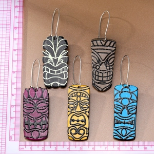 Detailed view of colorful tiki totem acrylic earrings with 5cm drop length and silver hooks