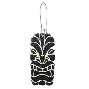 Detail of African tribal Tiki mask earrings with green engraved lines on black acrylic