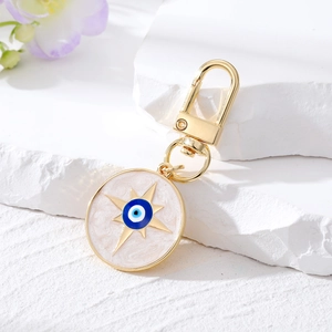 Goldener Evil Eye Schlüsselanhänger mit weißem Marmor-Sternanhänger und Karabiner