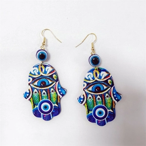 Bohemian Hamsa hand earrings with colorful floral patterns and evil eye charms