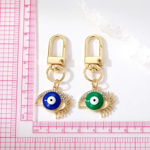 Detailed size measurement of colorful evil eye keychains with blue and green crystals