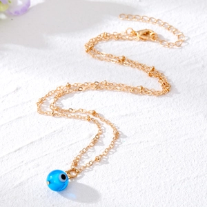 Vintage evil eye pendant necklace with a blue resin bead and adjustable gold chain