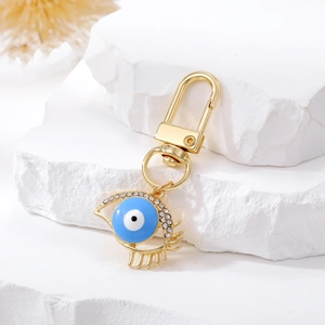 Ethnic style golden evil eye keychain with blue enamel and sparkling rhinestones