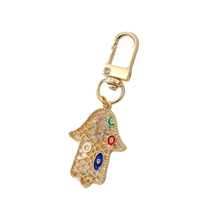 Auffälliger Hamsa-Hand-Schlüsselanhänger mit blauem Teufelsauge und goldenem Metall-Finish