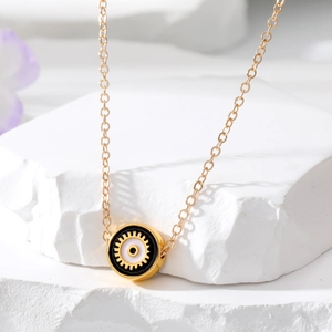 Ethnic Turkish evil eye necklace featuring a gold alloy round pendant on a white stone base