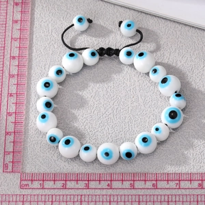 Adjustable evil eye beaded bracelet with white ceramic beads and black braided rope