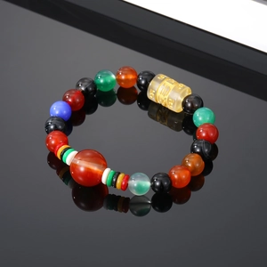 Close-up of vintage agate beaded bracelet with a translucent amber mantra bead