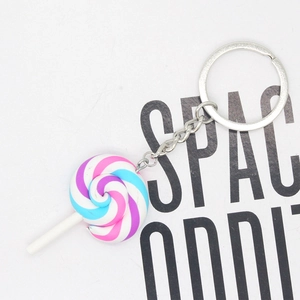 Detail shot of the pastel swirl polymer clay lollipop keychain with silver metal clip