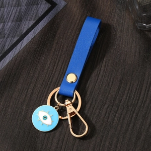 Ethnic blue leather Evil Eye keychain with gold hardware and pearl heart charm detail