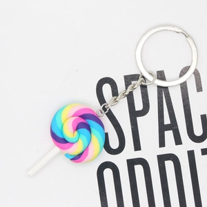 Detailed view of rainbow lollipop keychain with colorful resin swirl and silver metal ring