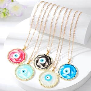 Group display of colorful Evil Eye pendant necklaces in five shades on white stands