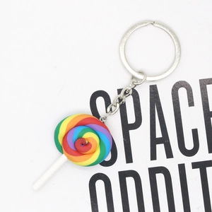 Close-up of colorful polymer clay rainbow lollipop keychain with silver metal ring