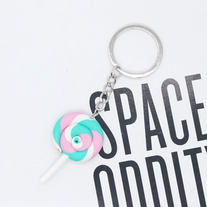 Macro shot of colorful spiral rainbow lollipop keychain with silver metal ring and chain