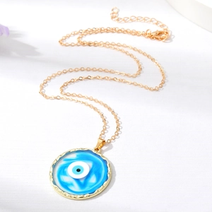 Golden Evil Eye pendant necklace with blue and white resin on a detailed curb chain