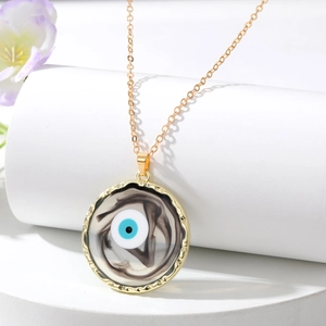 Macro detail of Evil Eye pendant with gold wave edge and swirling marble resin texture