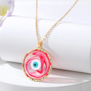 Detail of pink marble textured evil eye pendant on gold chain for fashion jewelry