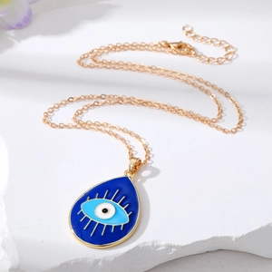 Golden alloy necklace with blue evil eye waterdrop pendant on a white stone base
