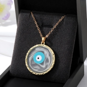 Turkish Evil Eye necklace with gold chain and marble texture pendant in a black gift box